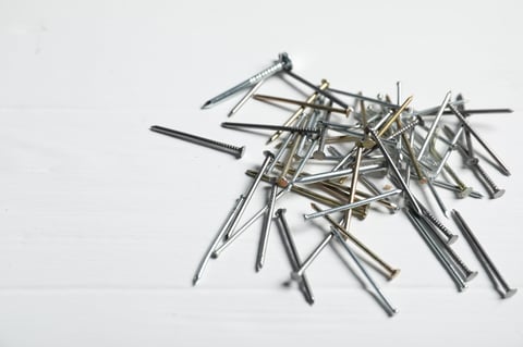 Galvanised round wire nails on white background